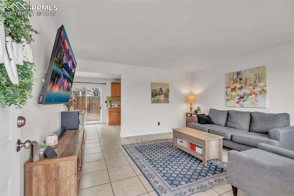 Living room with light tile patterned floors and baseboards