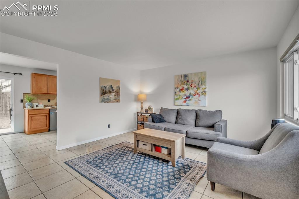 Living area featuring light tile patterned floors and baseboards