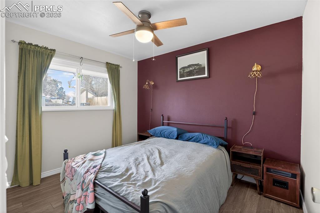 Bedroom with wood finished floors and ceiling fan
