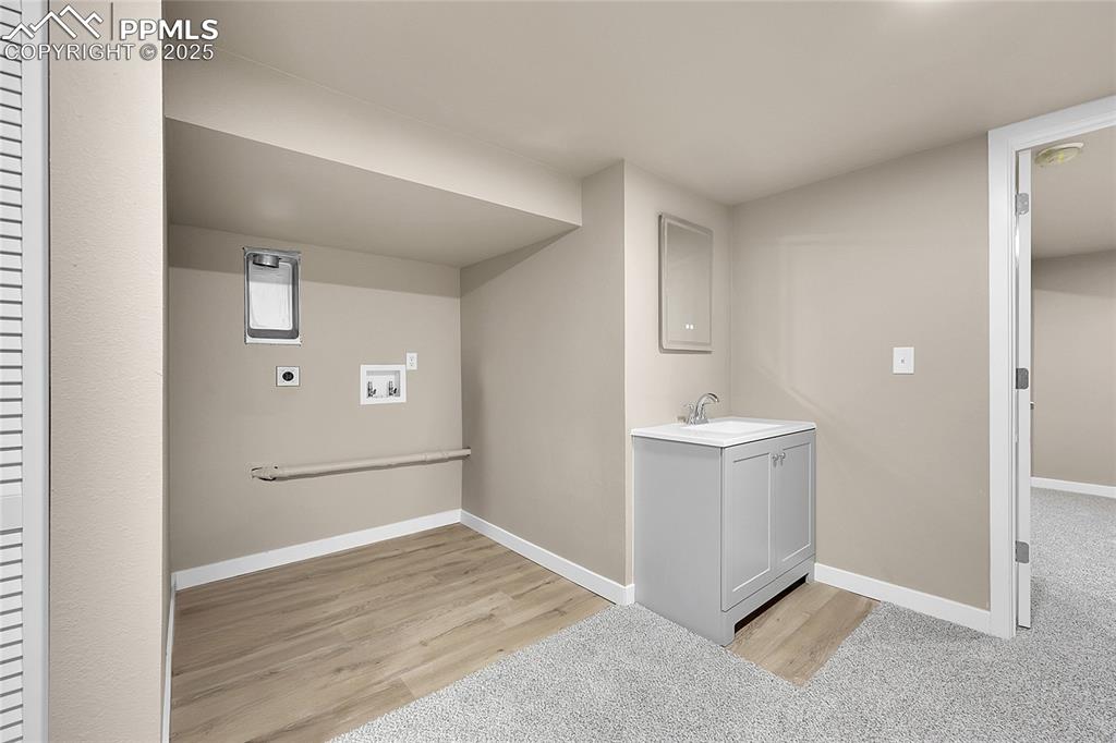 Washroom with washer hookup, light wood-style floors, and electric dryer hookup