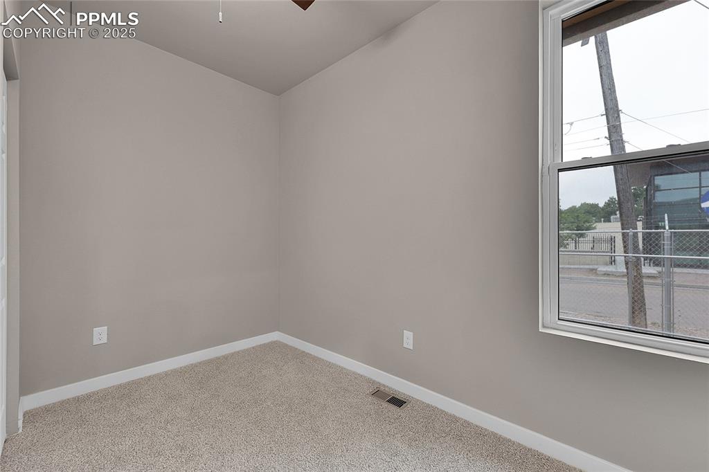 Unfurnished room with carpet, ceiling fan, and lofted ceiling
