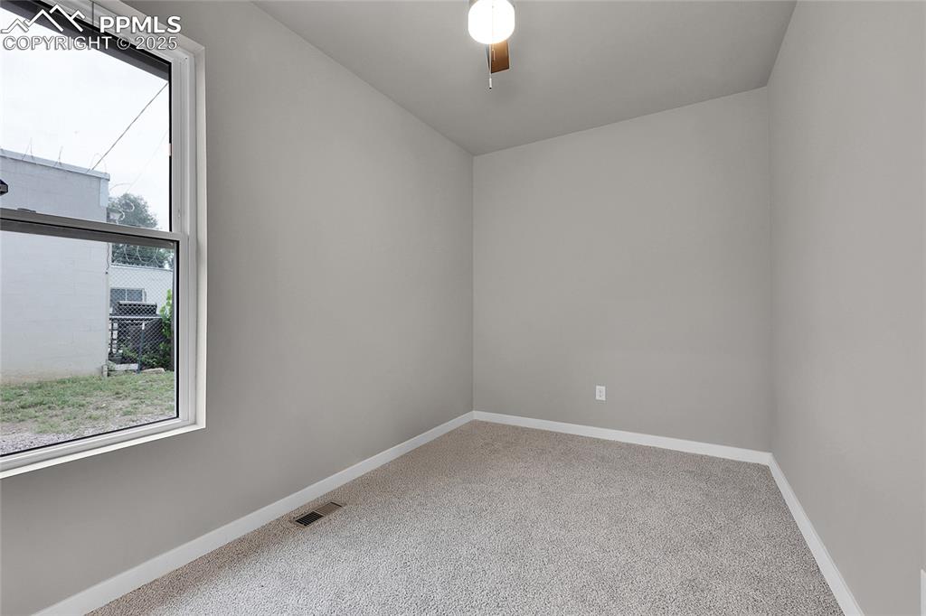 Spare room featuring light carpet and baseboards