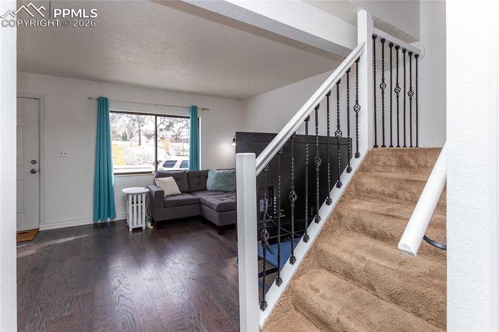 Stairway featuring wood finished floors and baseboards