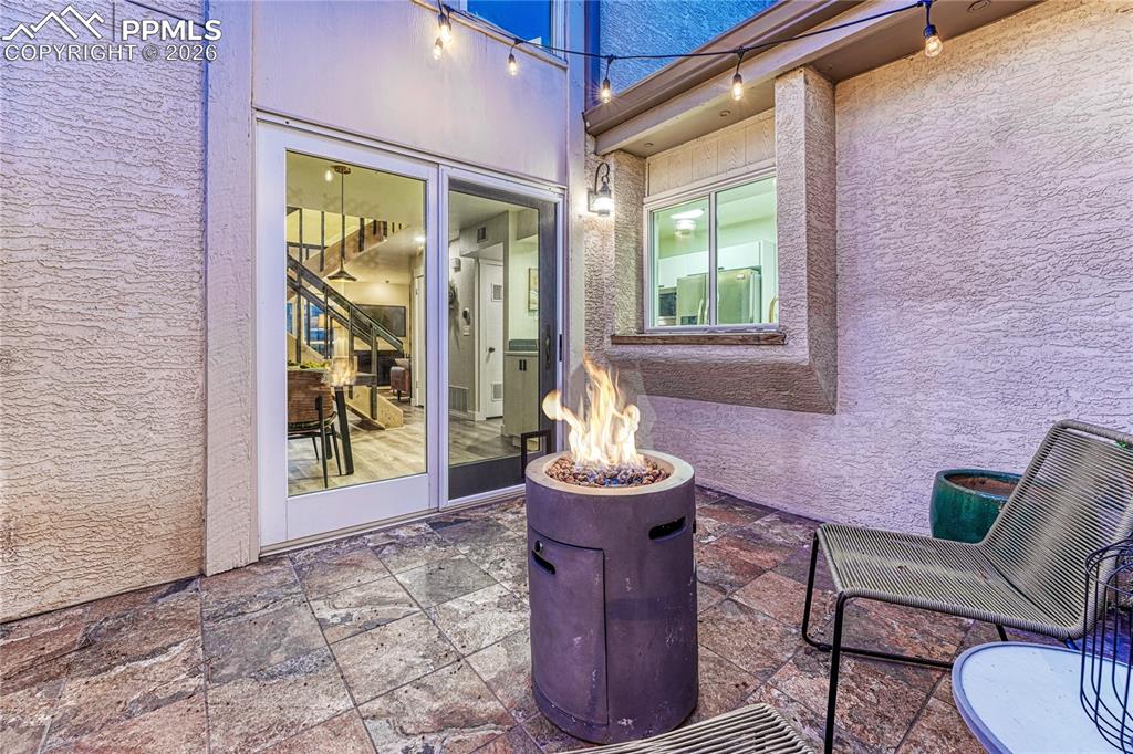 Patio with a fence to the side and back yards, perfect lighting to grow pots of plants to create your own secret garden.
