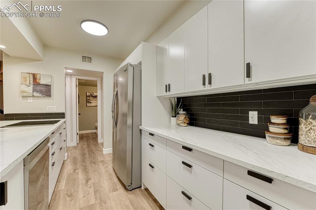At the end of the kitchen is the laundry room and garage door entry