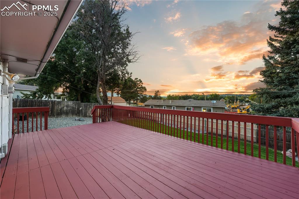 Wooden deck featuring a fenced backyard