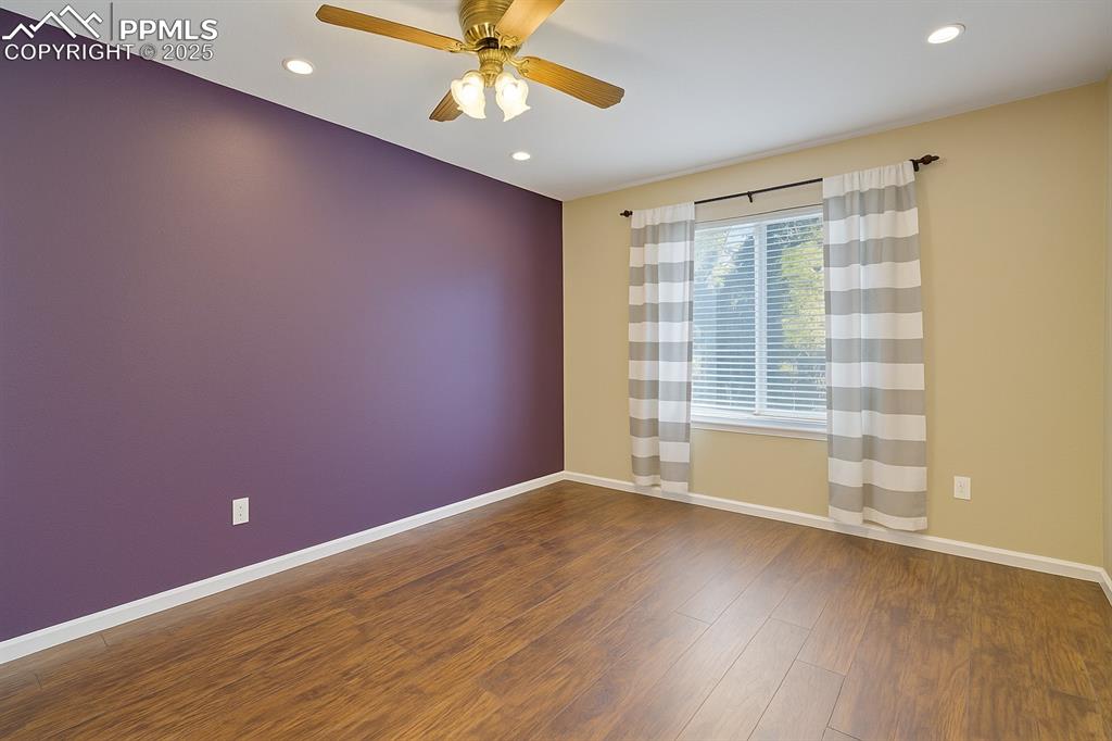 Unfurnished room with dark wood finished floors, recessed lighting, and a ceiling fan