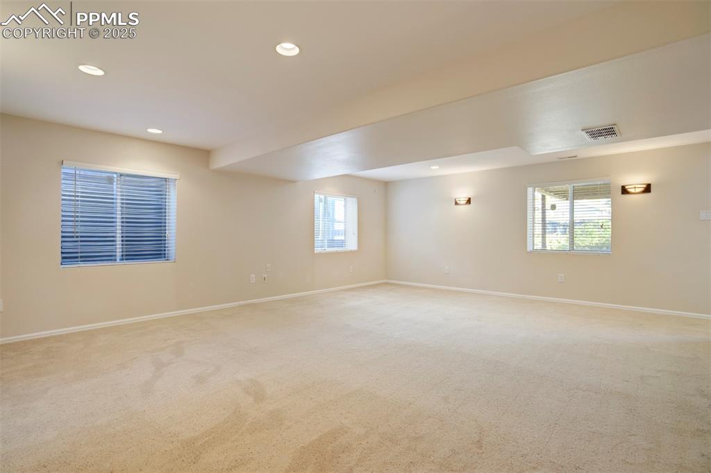 Empty room with recessed lighting and carpet