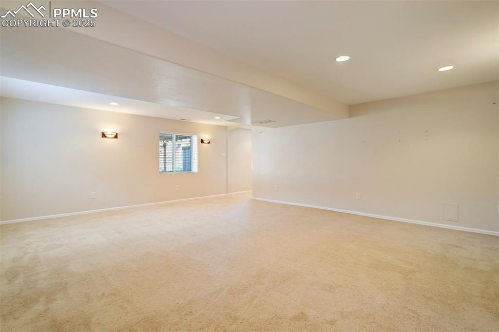 Empty room featuring recessed lighting and light colored carpet
