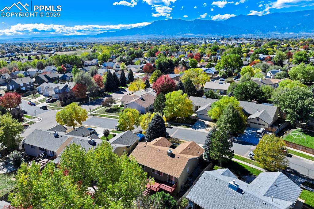 Aerial perspective of suburban area featuring a mountainous background