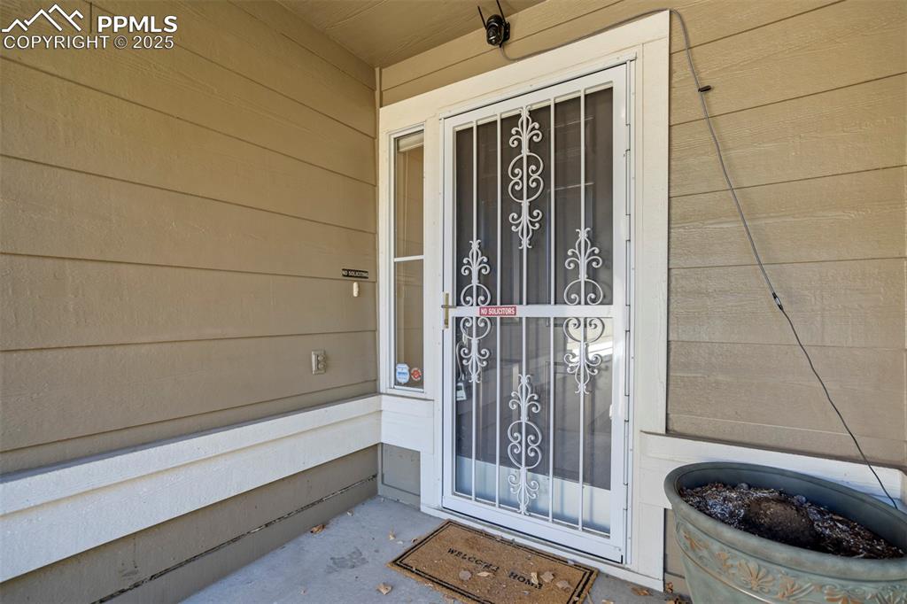 View of exterior entry with covered porch