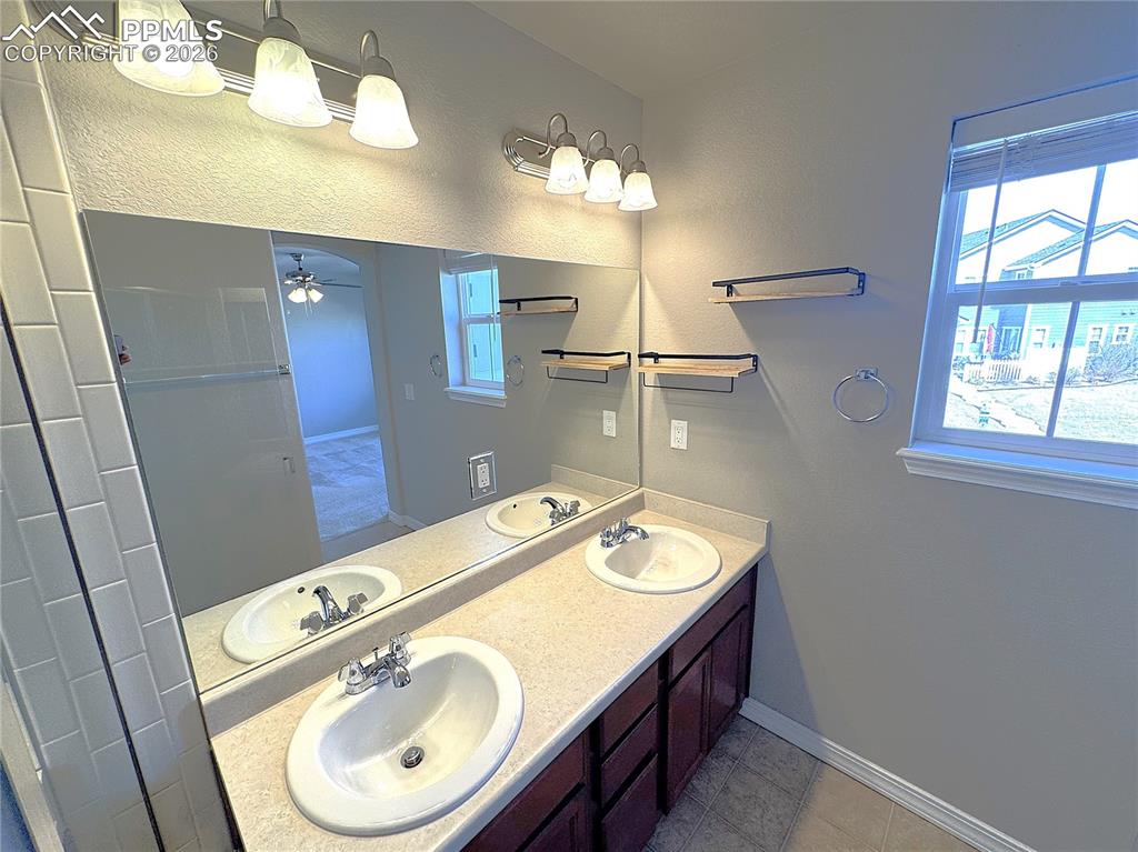 Primary Ensuite Bathroom with Double Vanity, Private Toilet, & Large Shower