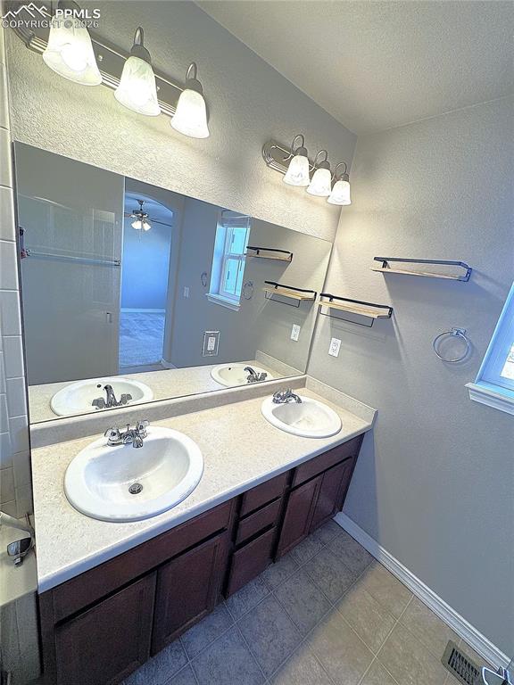 Primary Ensuite Bathroom with Double Vanity, Private Toilet, & Large Shower