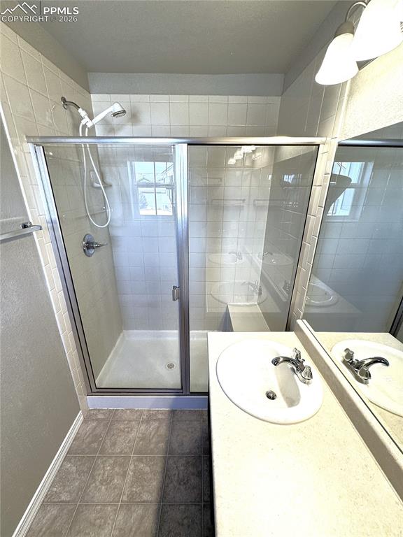 Primary Ensuite Bathroom with Double Vanity, Private Toilet, & Large Shower