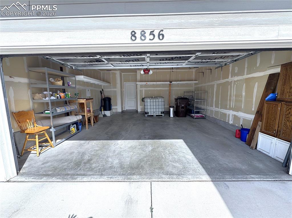 Finished Garage with Garage Door Opener and Storage