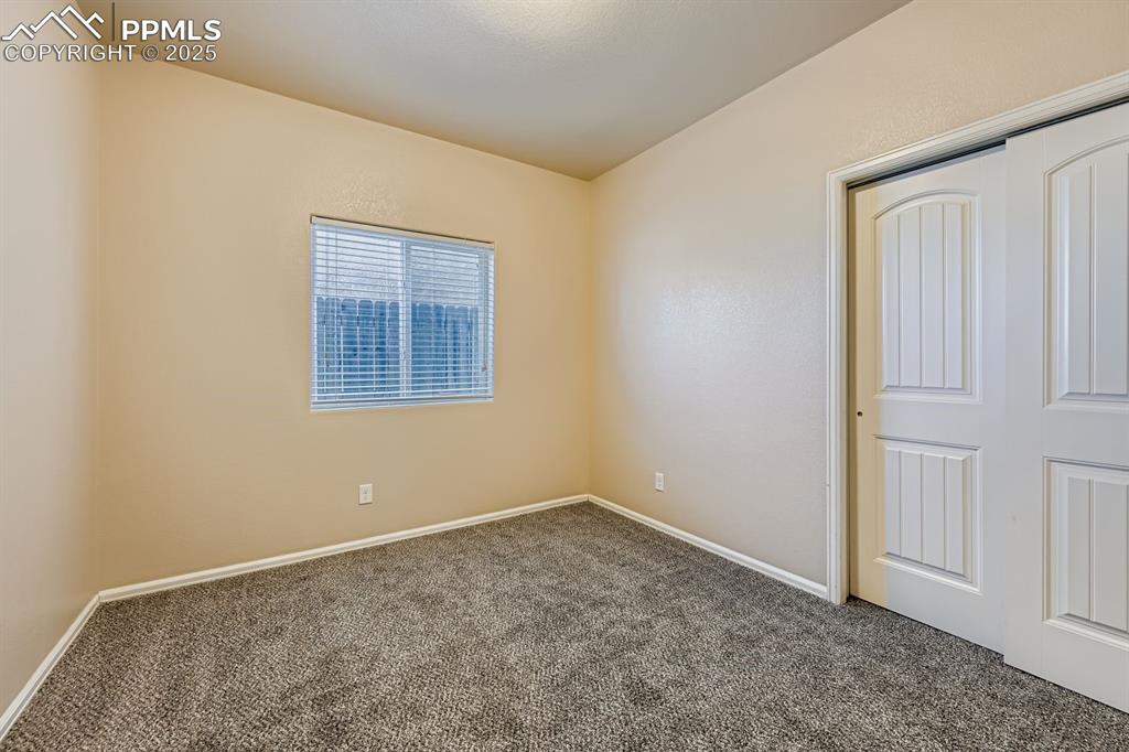 Unfurnished bedroom featuring carpet flooring and a closet