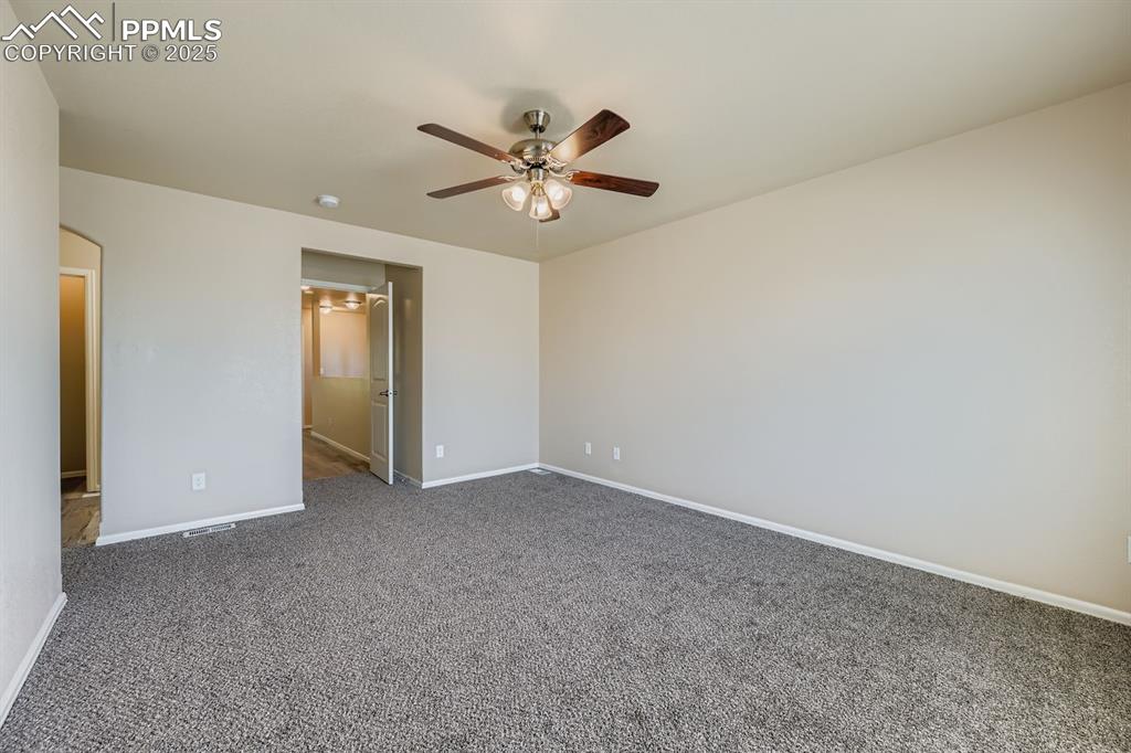 Unfurnished bedroom with carpet floors and ceiling fan