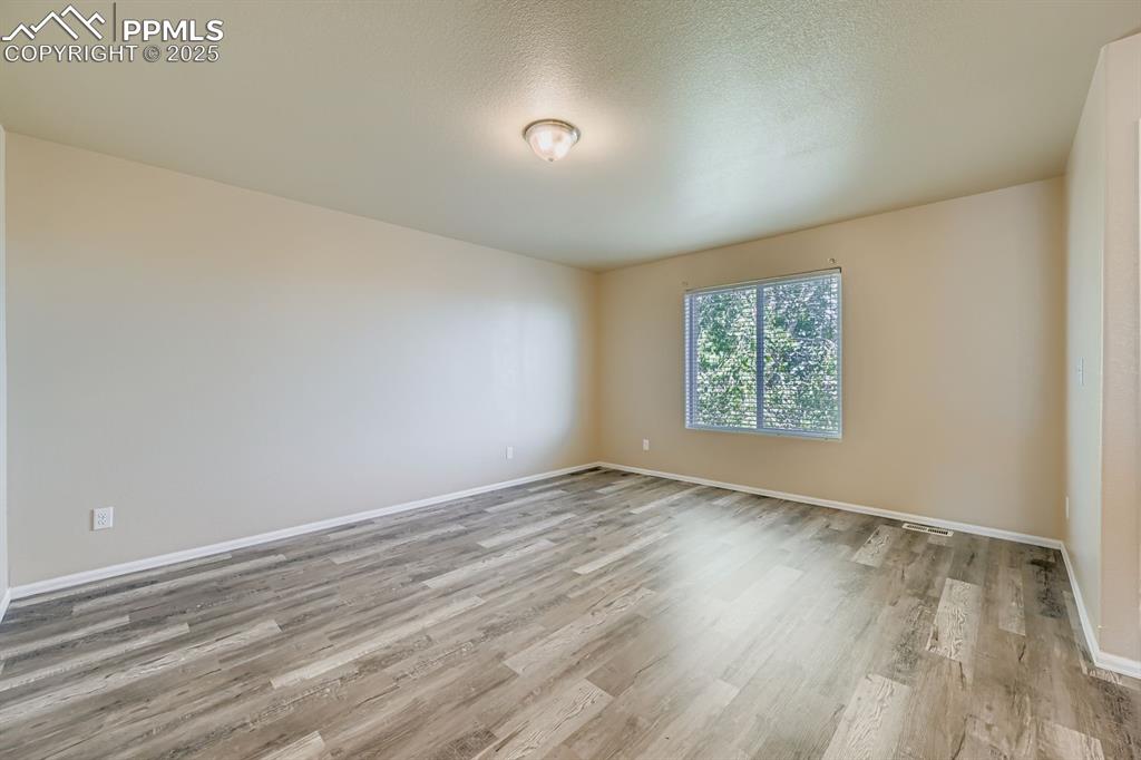 Spare room with light wood-style flooring and a textured ceiling