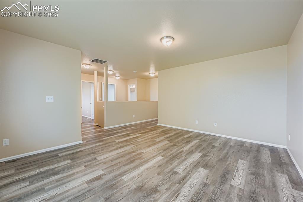 Empty room featuring light wood-style flooring and baseboards