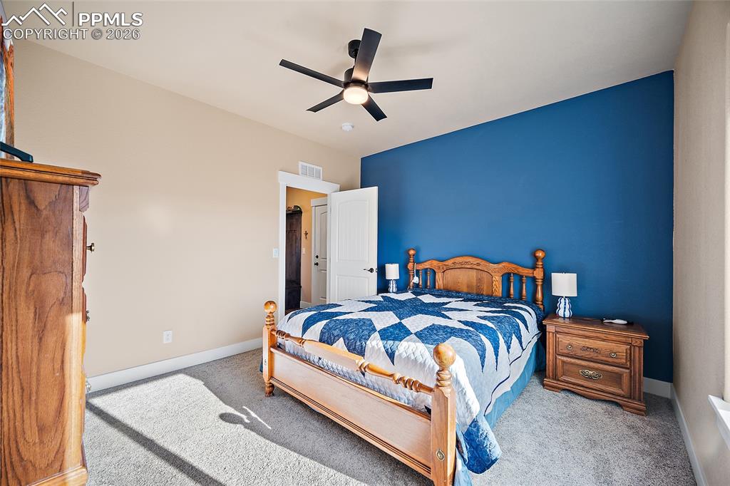 Main level bedroom with walk in closet and private bathroom.