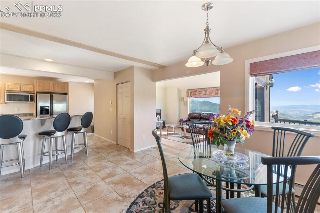 Dining space with light tile patterned flooring and a mountain view