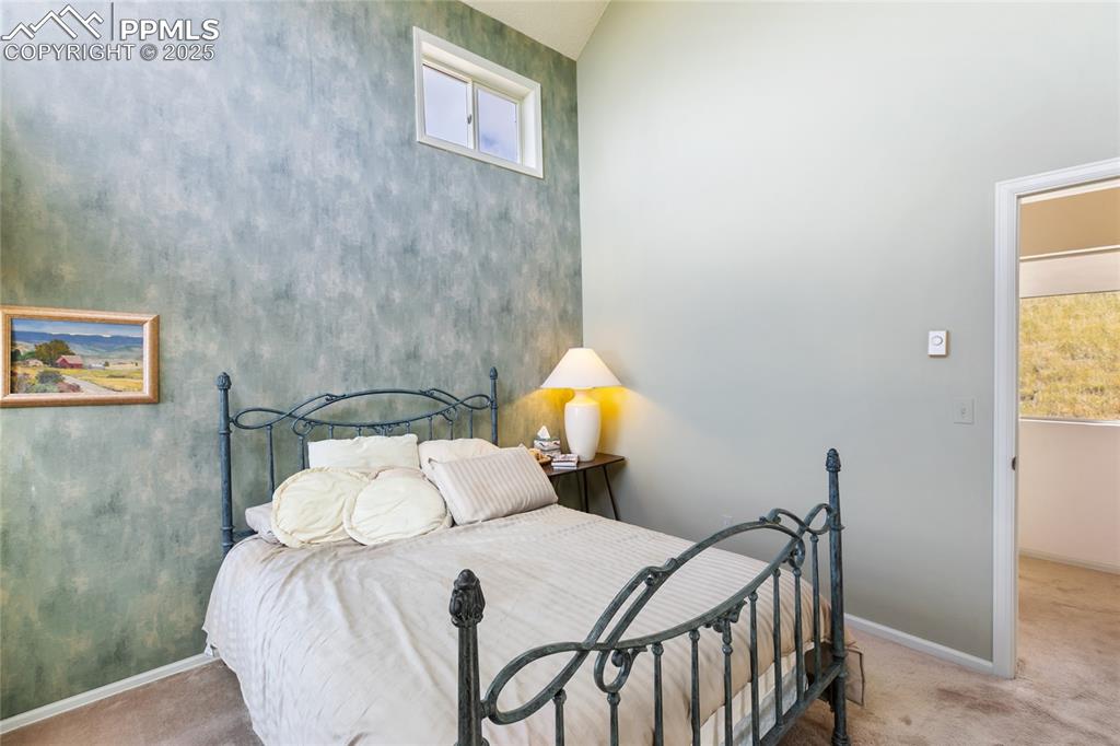 Carpeted bedroom with baseboards