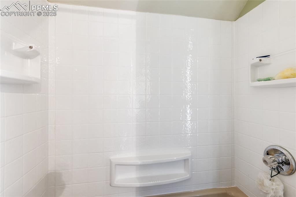 Bathroom featuring tile walls