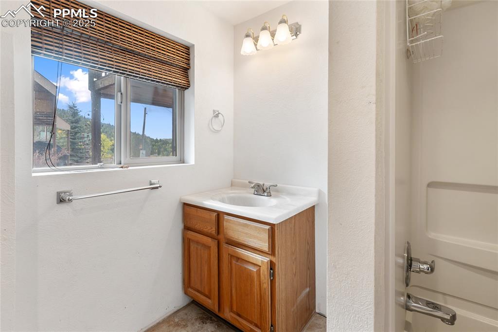 Full bath featuring vanity and  shower combination