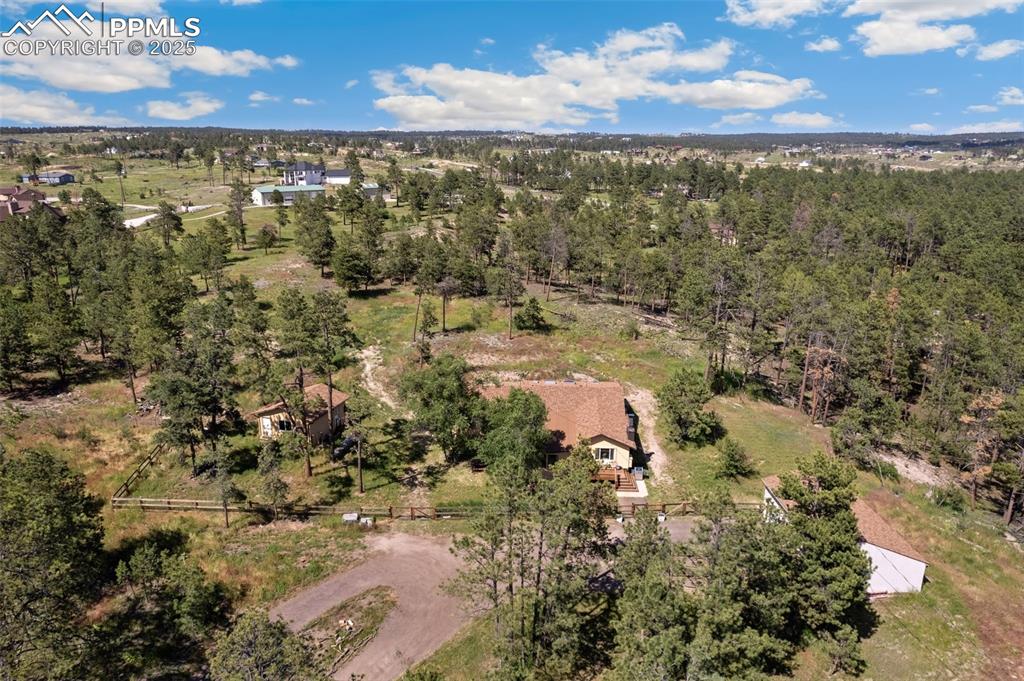 Facing North, showing driveway and all three structures