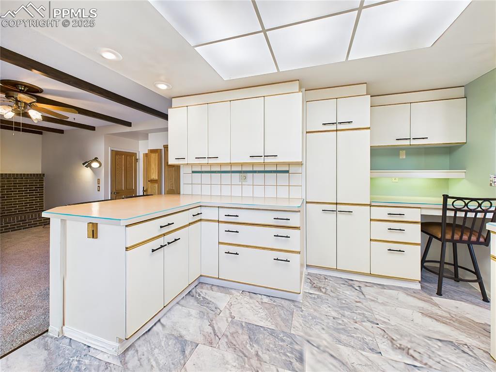 Kitchen Storage & Built-In Desk – Smart kitchen design includes built-in desk with file drawers, rotating spice shelves, and pull-out cabinet storage for enhanced organization.