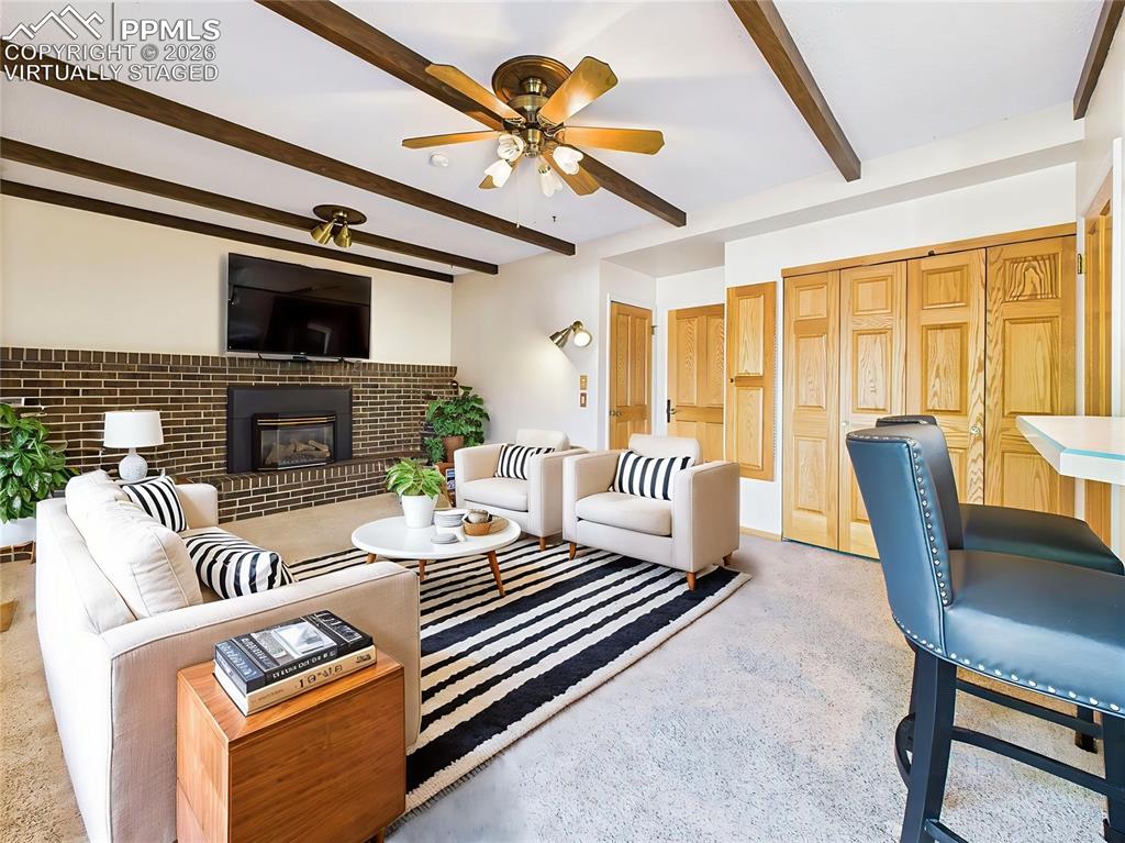 Virtually Staged Family Room to showcase layout flexibility, this warm gathering space includes a ceiling fan, closet storage, and views into the bright kitchen.