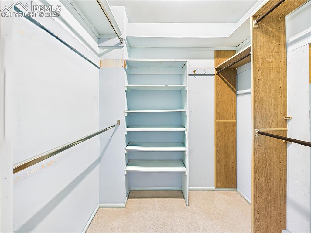 Walk-In Closet, this custom closet offers built-in shelving and hanging space for ample wardrobe storage.