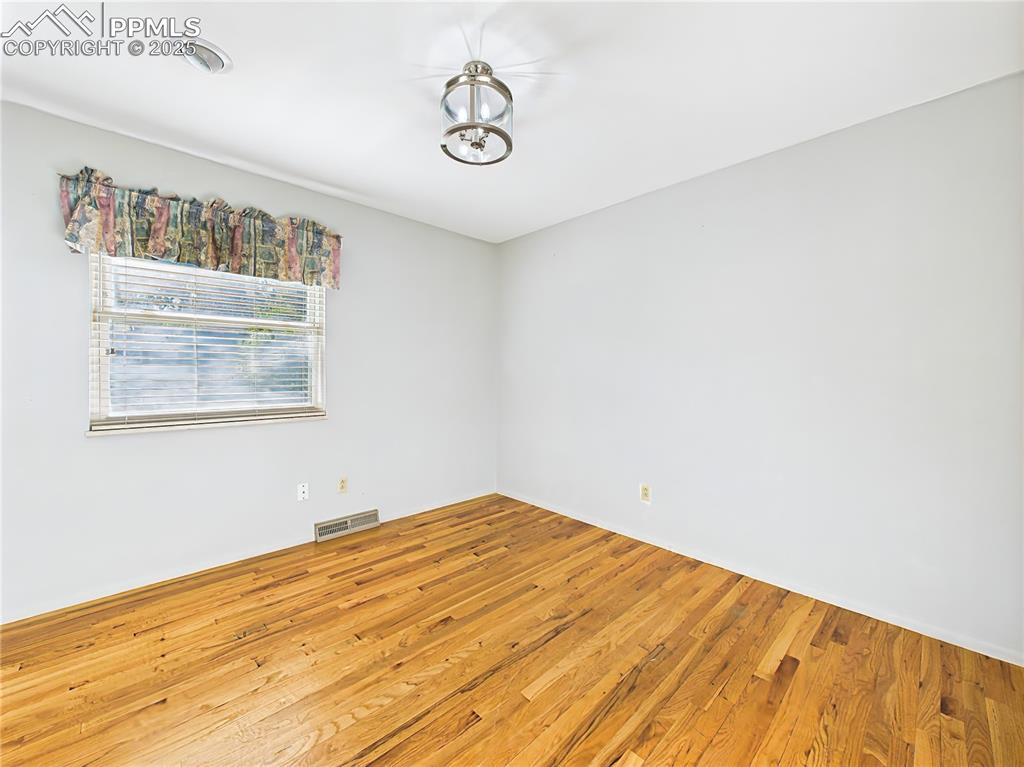 Bedroom 2 (Unfurnished) – With hardwood flooring and great natural light, this bedroom is a versatile option for any household need.