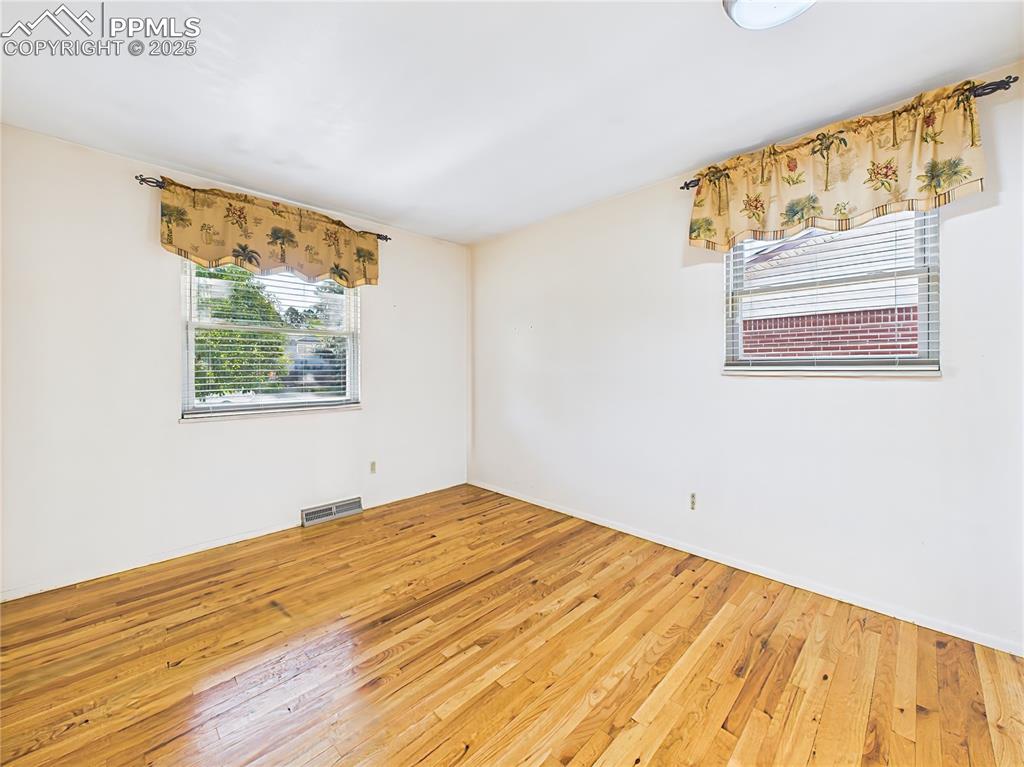 Bedroom 3 (Unfurnished) – Crisp and updated, this bedroom is move-in ready with hardwood floors and ample closet space behind sliding doors.