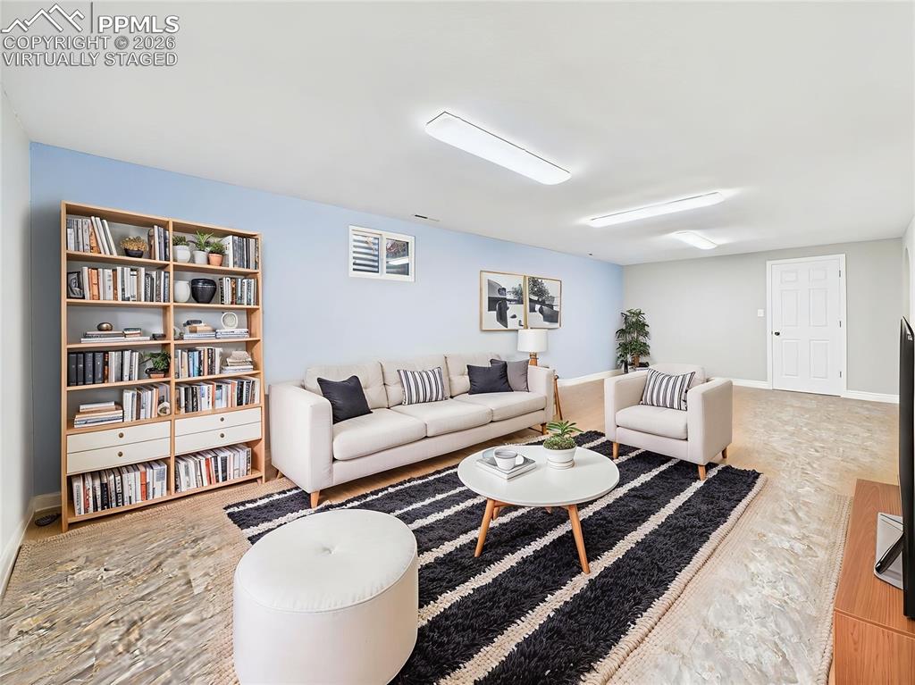 Virtually Staged Basement Entertaining Area alternate view of this large basement living space shows its versatility for TV viewing, play, or relaxation with abundant square footage.