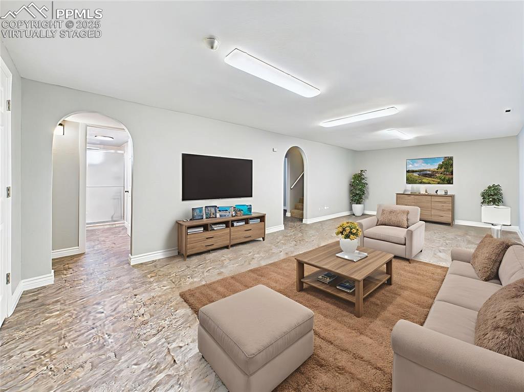 Virtually Staged Basement Living Area is the massive secondary living space—great for gatherings, home theater, or a game room setup.