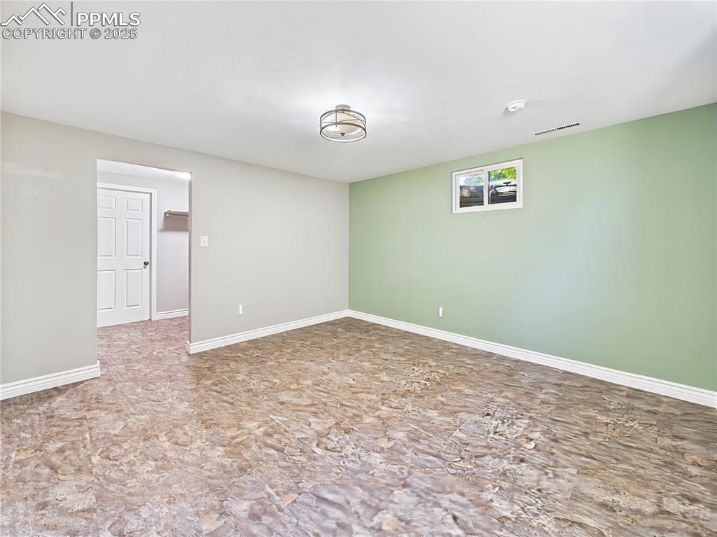 Basement Bedroom (Unfurnished) – Generously sized basement bedroom with calming tones and upgraded luxury flooring—ideal as a guest suite, office, or hobby space.