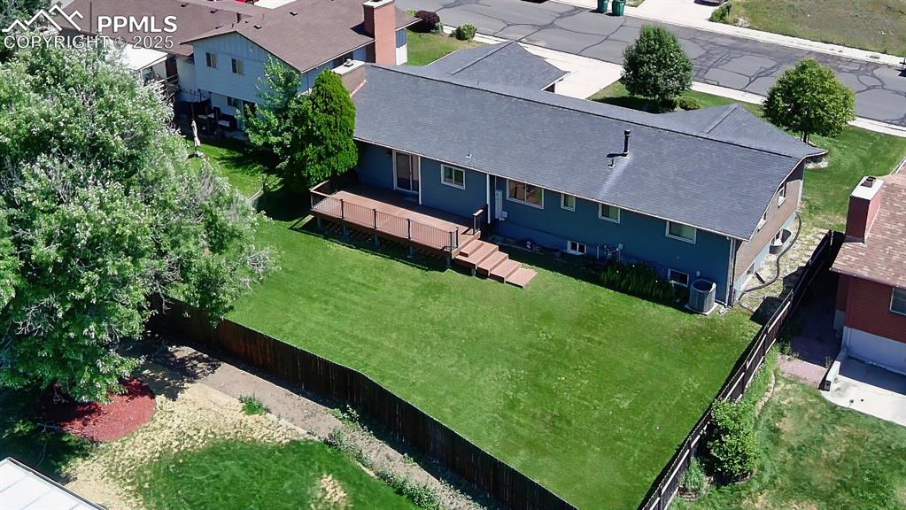 Backyard Overview – Expansive, fully fenced backyard with two gates and mature landscaping offers privacy and room to roam—plus incredible views of Pikes Peak from the deck.