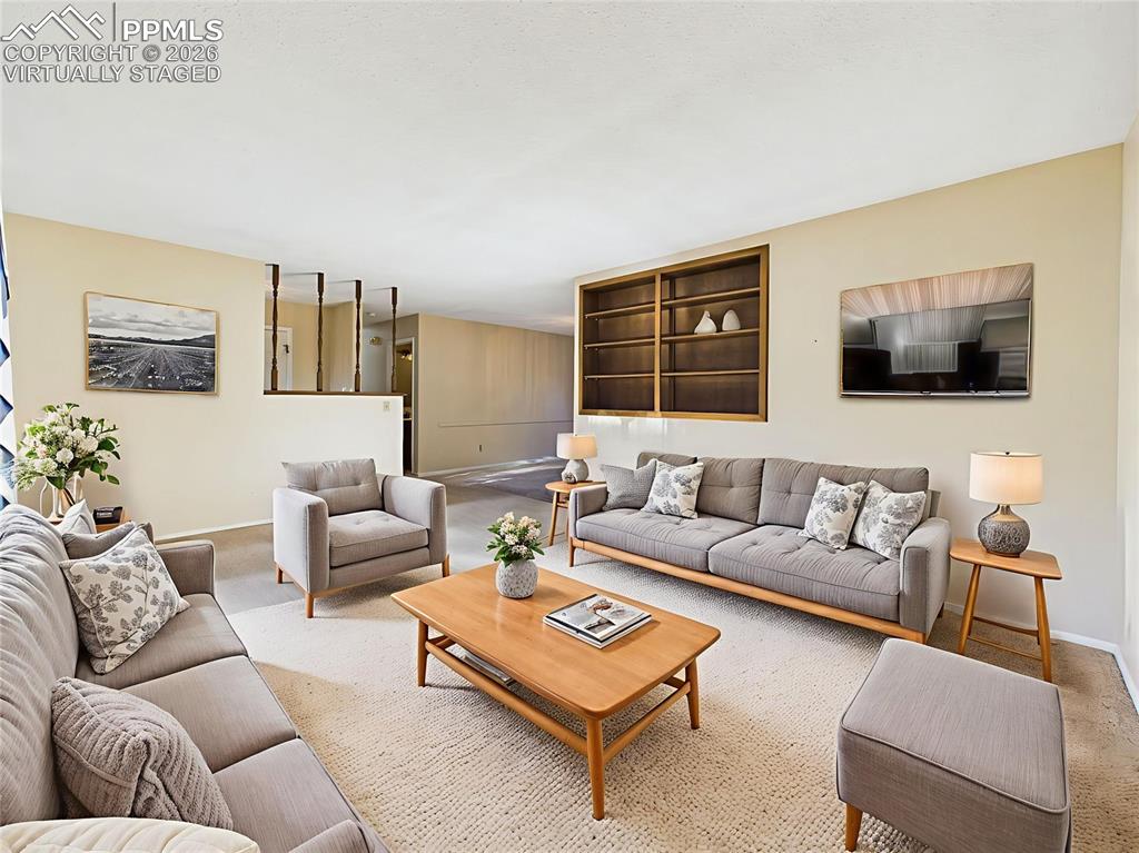 Virtually Staged Living Room to Formal Dining View – The virtually staged layout demonstrates how this expansive living space can be beautifully arranged with built-in bookshelves and media area.