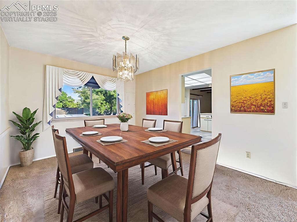 Virtually Staged Formal Dining Room shows how this bright dining space can comfortably host gatherings while overlooking leafy treetops.