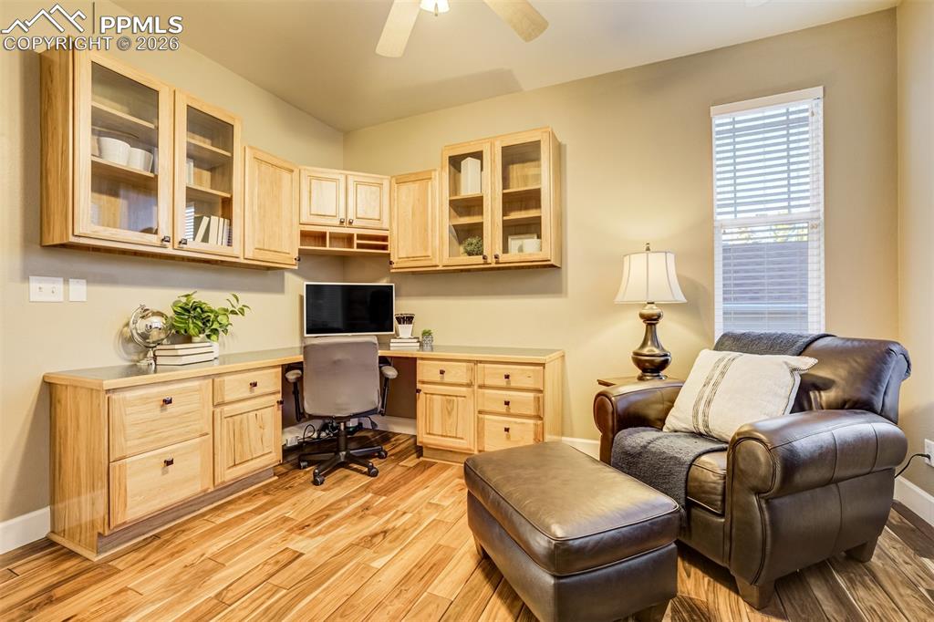 An executive style office with built in cabinetry and work space