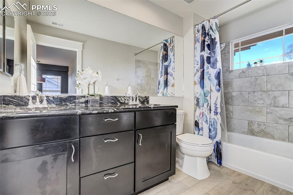 Full bathroom on upper level with granite counter and double vanity