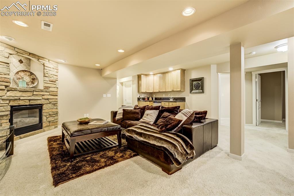 A fireplace and wet bar provide a perfect space for a movie night!