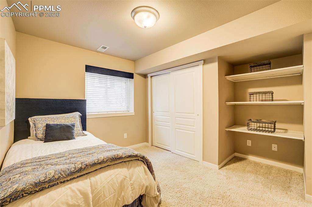 A 6th bedroom in basement with extra shelving