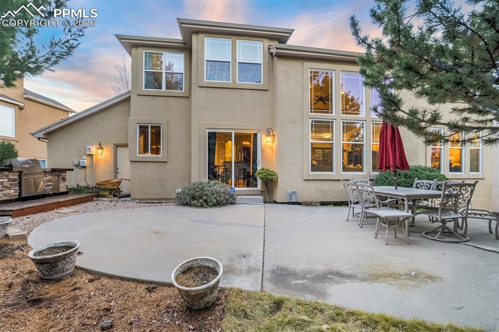 The backyard is a private oasis surrounded by mature trees