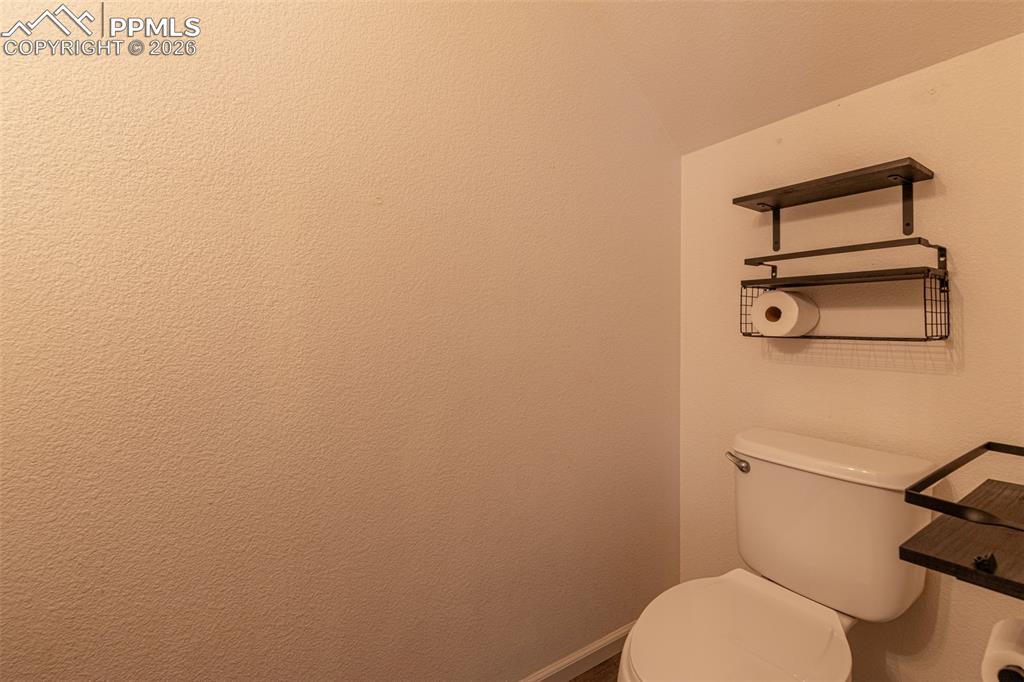 Bathroom featuring toilet and baseboards