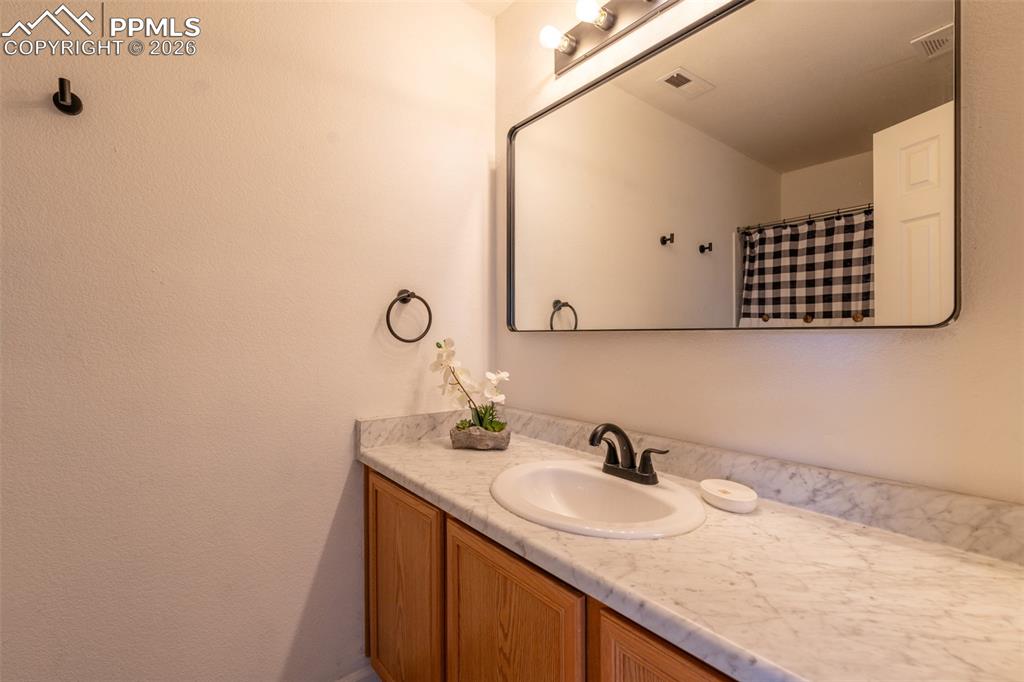 Full bath with vanity and curtained shower