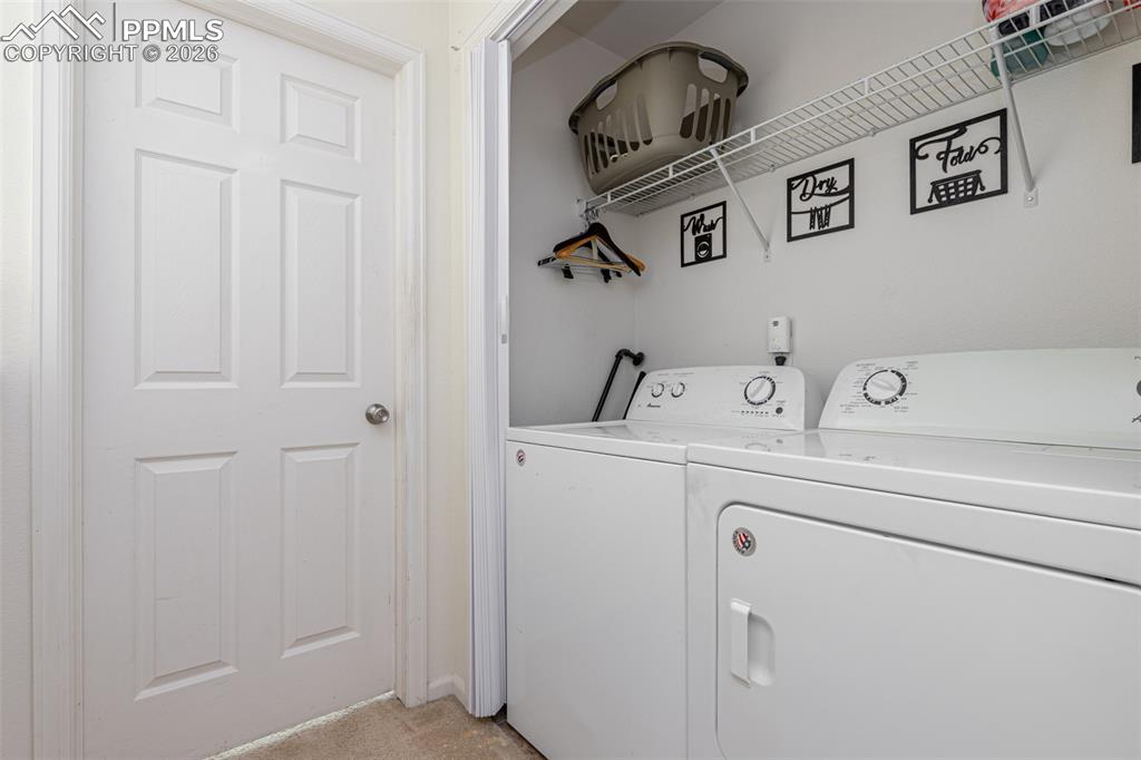 Laundry area featuring washing machine and clothes dryer that will stay