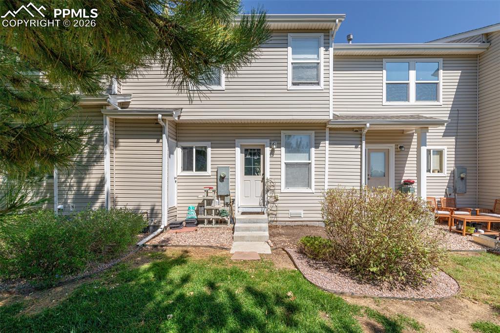 Rear view of house with a yard