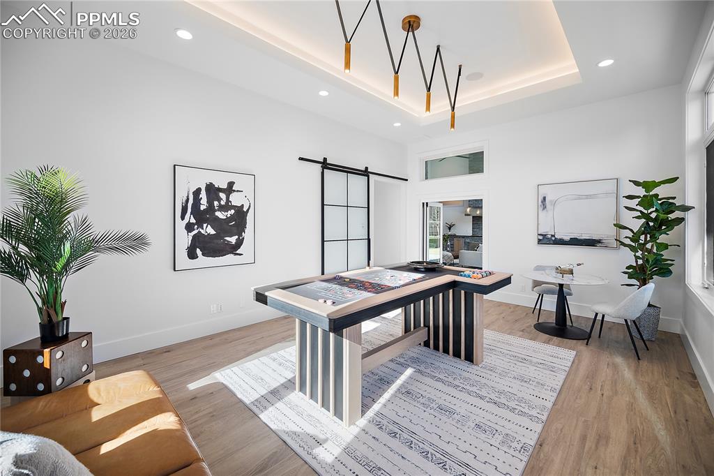 A versatile game or bonus room that opens to the patio, perfect for entertaining, recreation, or a private exercise space.